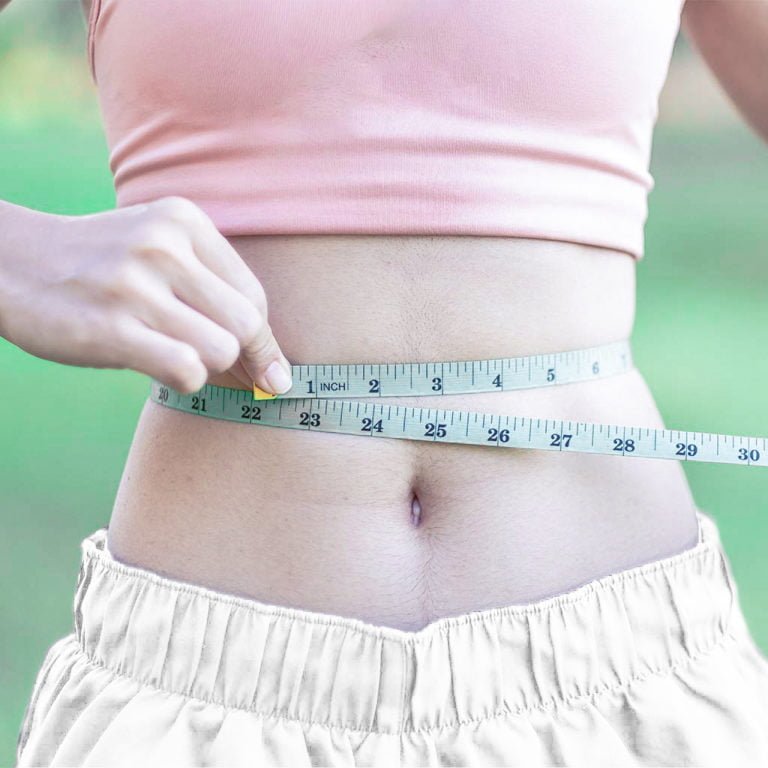 Young slim body female in pink sportswear, healthy woman measuri